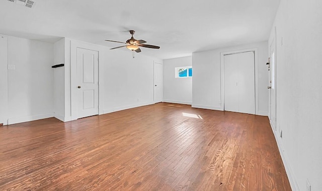 spare room with ceiling fan and dark hardwood / wood-style floors