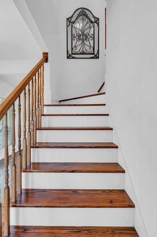 stairs with hardwood / wood-style floors