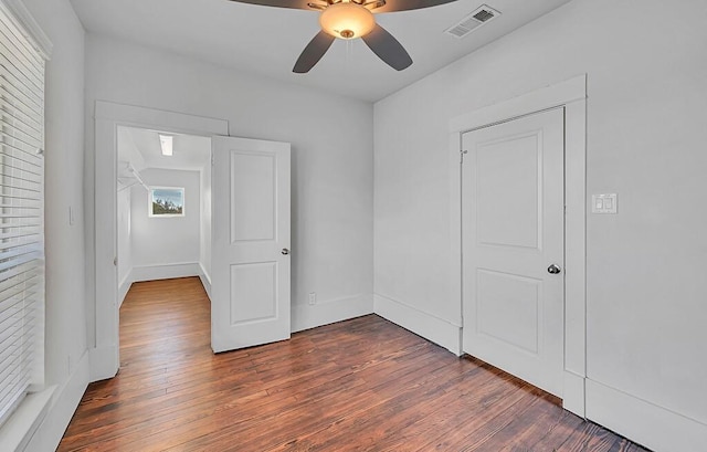 spare room with ceiling fan and dark hardwood / wood-style flooring