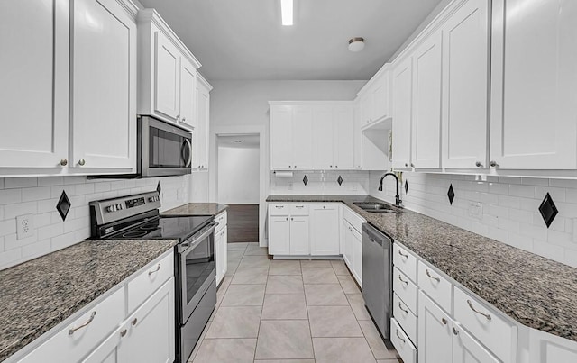 kitchen featuring white cabinets, sink, stainless steel appliances, and tasteful backsplash