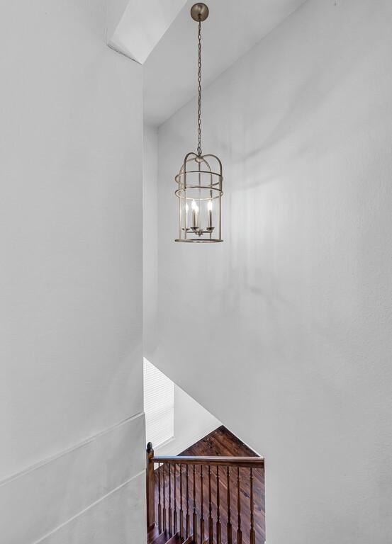 stairs with a chandelier