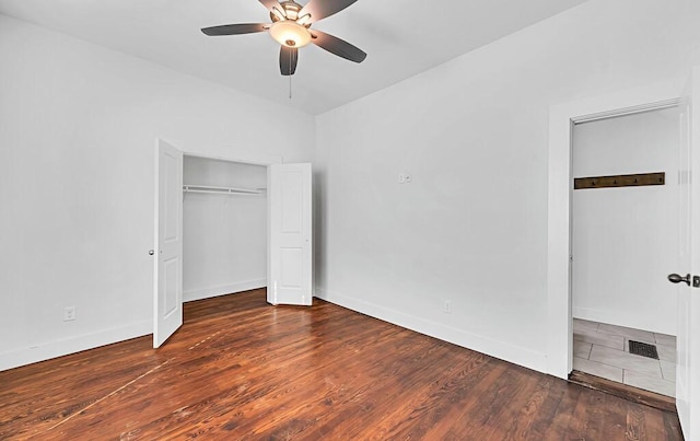 unfurnished bedroom with ceiling fan and dark hardwood / wood-style floors