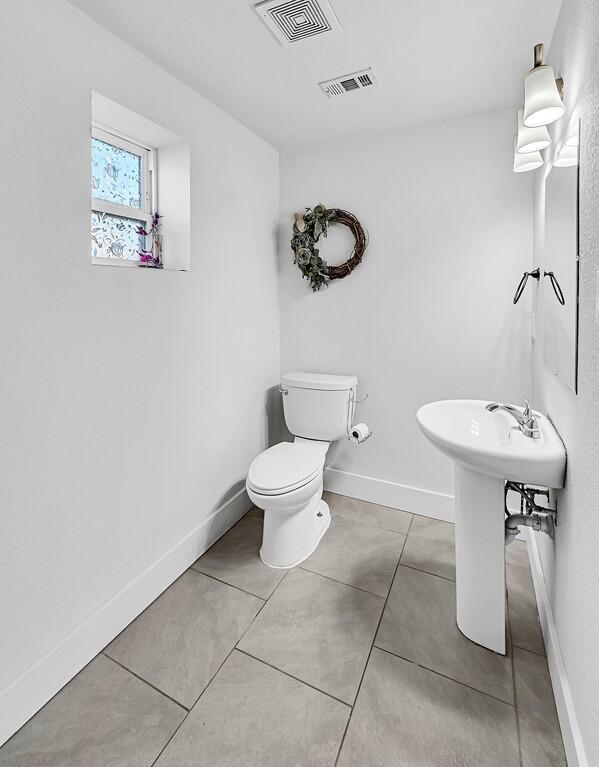 bathroom featuring tile patterned floors and toilet