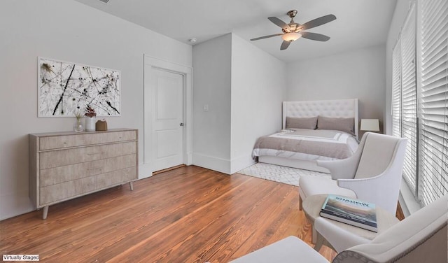 bedroom with wood-type flooring and ceiling fan