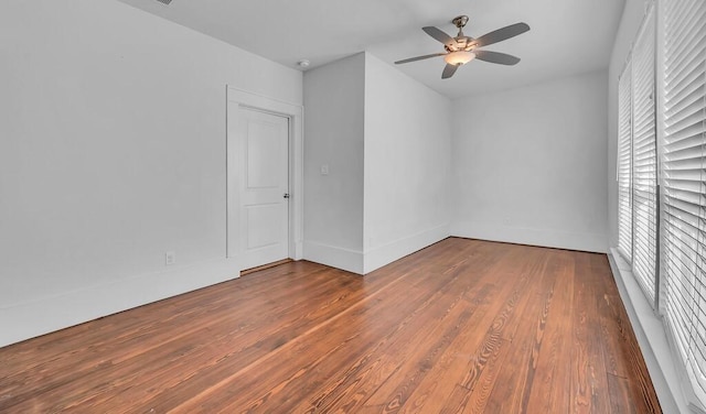 empty room featuring ceiling fan and hardwood / wood-style floors