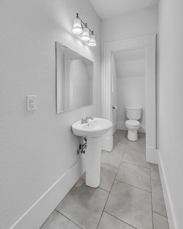 bathroom featuring tile patterned flooring and toilet