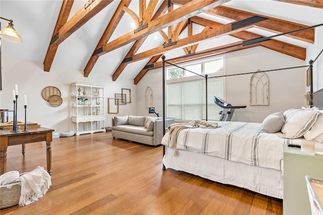 bedroom with hardwood / wood-style floors, beamed ceiling, and high vaulted ceiling