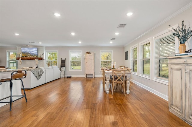 dining room featuring light hardwood / wood-style floors and ornamental molding