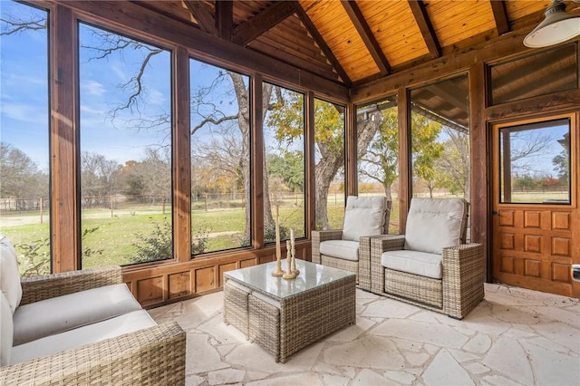 sunroom featuring lofted ceiling with beams and wooden ceiling