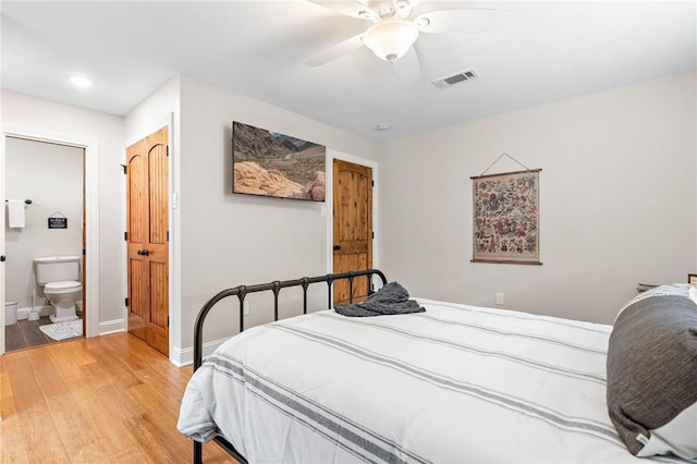 bedroom featuring ensuite bath, ceiling fan, and wood-type flooring