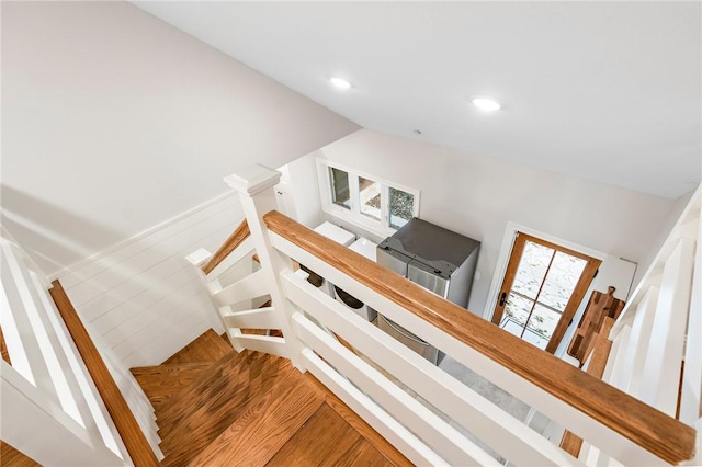 stairway with wood-type flooring and lofted ceiling