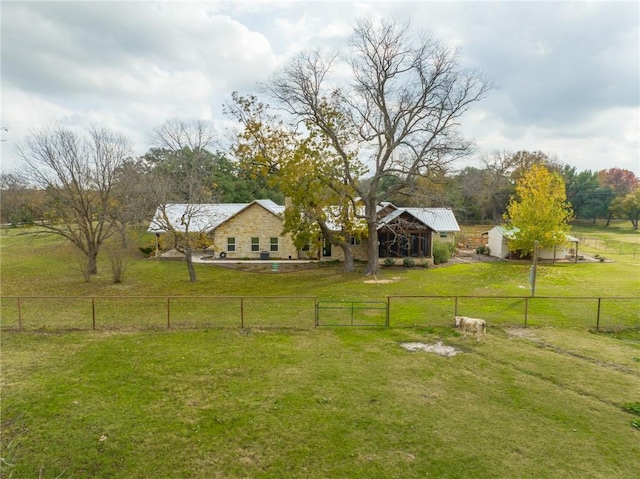 view of yard with an outbuilding and a rural view