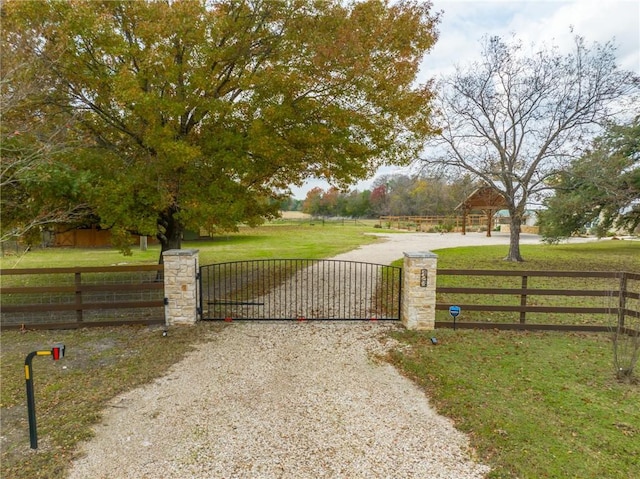 view of gate featuring a lawn