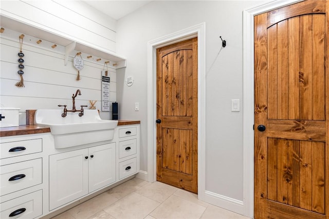 mudroom with light tile patterned floors and sink