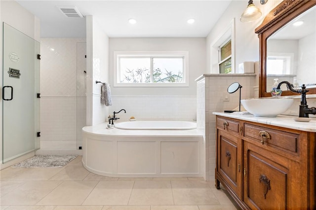 bathroom featuring tile patterned floors, vanity, separate shower and tub, and tile walls