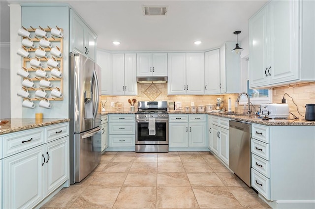 kitchen with sink, white cabinetry, stainless steel appliances, and hanging light fixtures