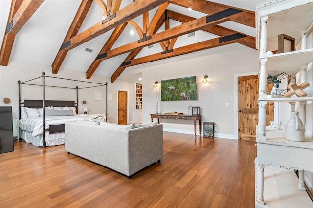 bedroom with hardwood / wood-style floors, high vaulted ceiling, and beam ceiling