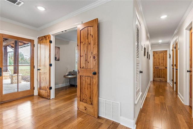 corridor featuring light wood-type flooring and crown molding