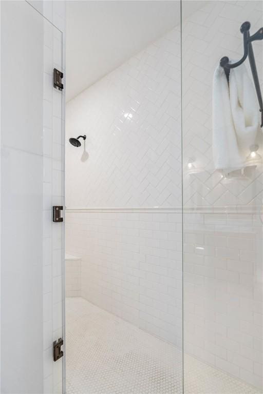 bathroom featuring a shower with shower door