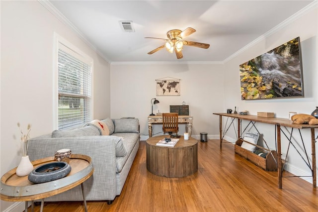 living room featuring ceiling fan, hardwood / wood-style floors, and ornamental molding