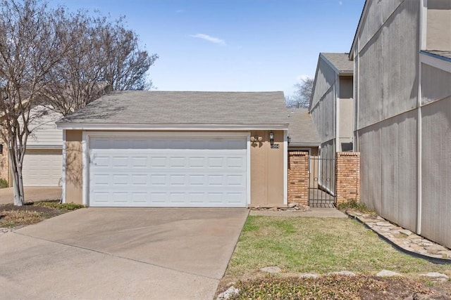 view of front of home with concrete driveway, brick siding, a garage, and a shingled roof