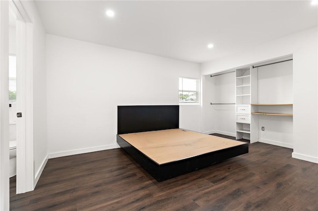 bedroom featuring dark hardwood / wood-style flooring, a closet, and built in desk