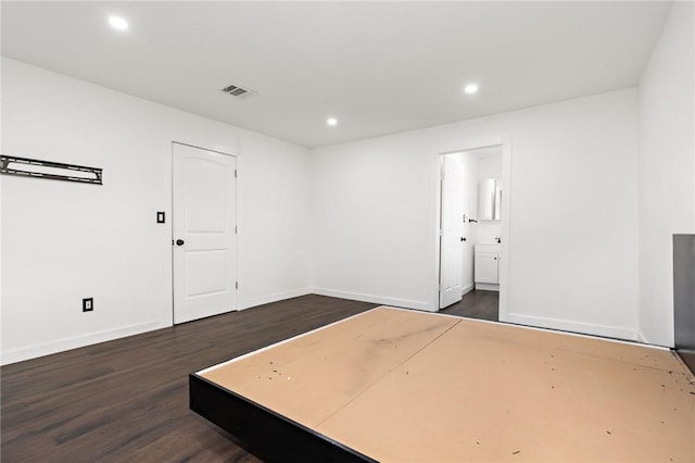 empty room with dark wood-type flooring