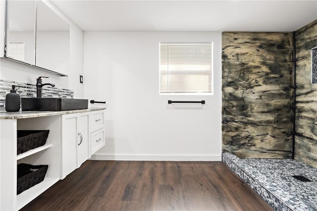 bathroom featuring vanity, wood-type flooring, and walk in shower