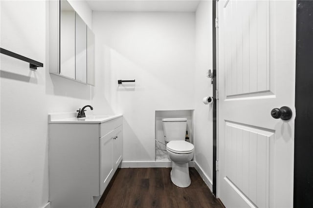 bathroom featuring vanity, toilet, and wood-type flooring