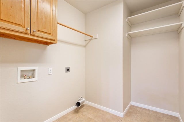 laundry area with hookup for an electric dryer, washer hookup, light tile patterned floors, and cabinets