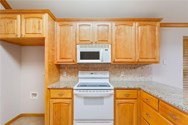 kitchen featuring light stone countertops, light tile patterned floors, white appliances, and tasteful backsplash