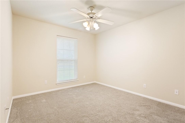 spare room featuring light carpet and ceiling fan