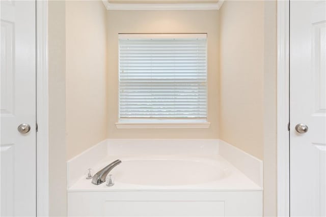 bathroom with a bathing tub and ornamental molding