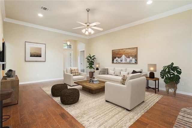 living room with wood-type flooring, ceiling fan, and ornamental molding