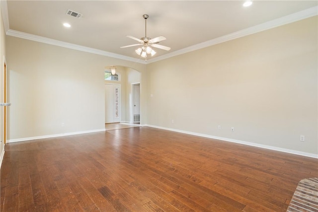 spare room featuring crown molding, ceiling fan, and dark wood-type flooring