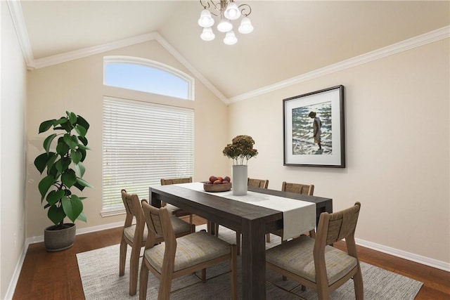 dining area featuring dark hardwood / wood-style flooring, an inviting chandelier, lofted ceiling, and ornamental molding