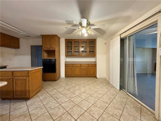 kitchen with oven, ceiling fan, and light tile patterned floors