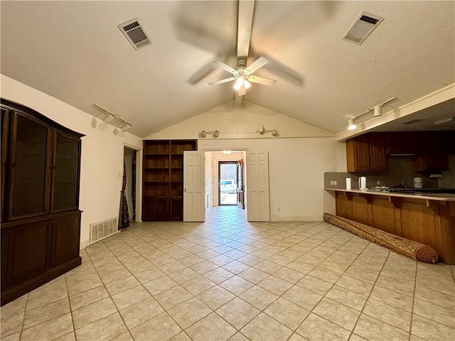 kitchen featuring light tile patterned floors, ceiling fan, and vaulted ceiling