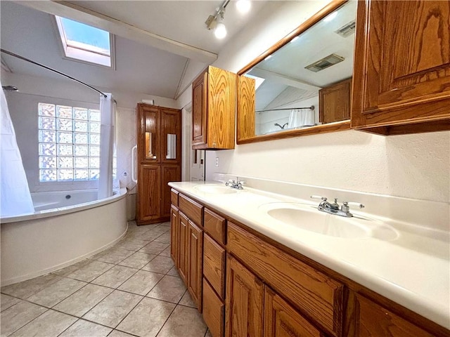 bathroom with vanity, vaulted ceiling with skylight, shower / bath combo, and tile patterned floors