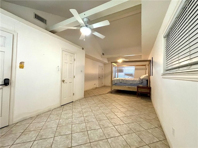 unfurnished bedroom with vaulted ceiling, ceiling fan, and light tile patterned floors