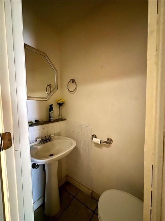 bathroom featuring toilet and tile patterned flooring