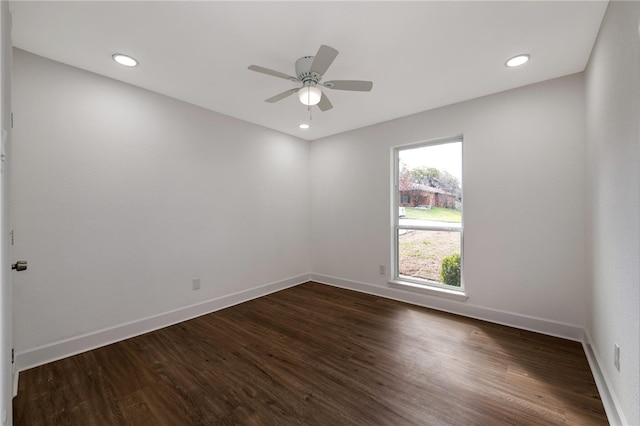 empty room with ceiling fan and dark hardwood / wood-style flooring