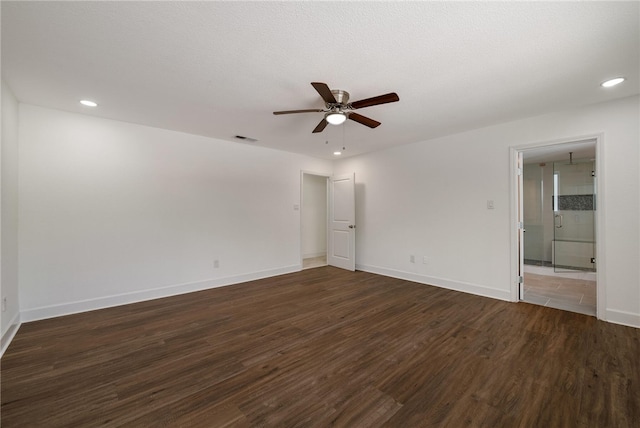 spare room with ceiling fan, dark hardwood / wood-style flooring, and a textured ceiling