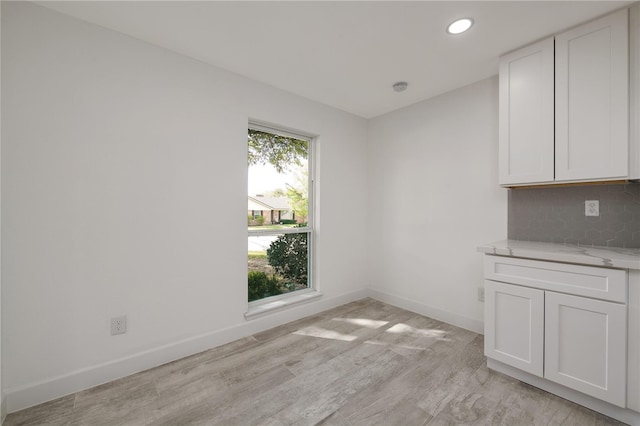 unfurnished dining area featuring light hardwood / wood-style flooring