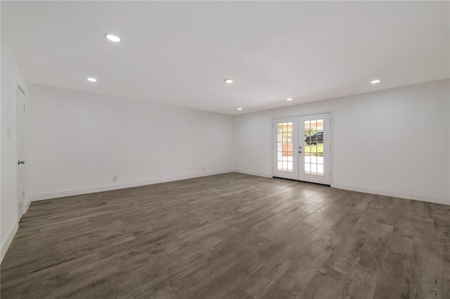 empty room featuring french doors and dark hardwood / wood-style flooring