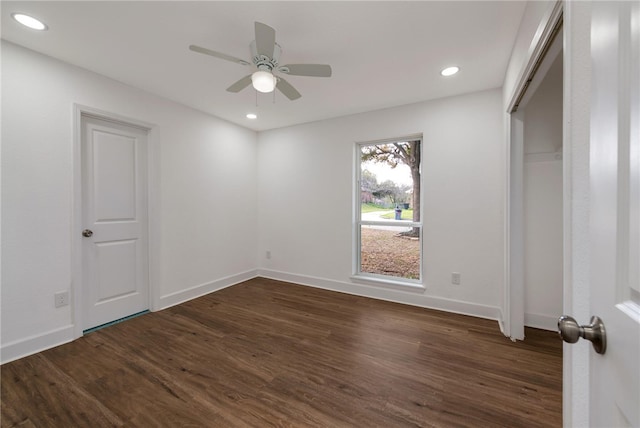 unfurnished bedroom with a closet, ceiling fan, and dark hardwood / wood-style flooring