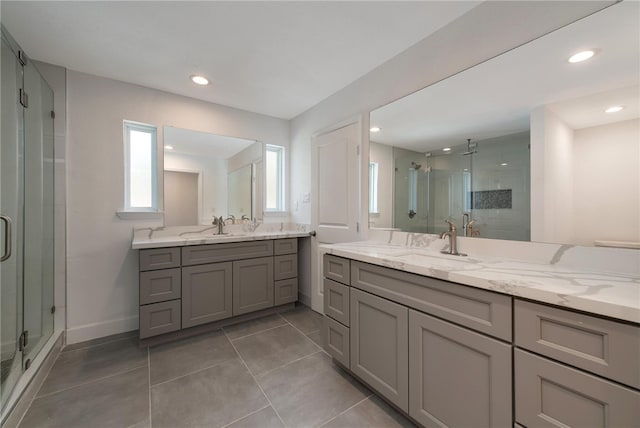 bathroom featuring vanity, tile patterned floors, and a shower with shower door