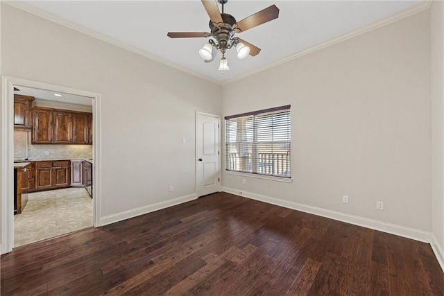 unfurnished room with ceiling fan, ornamental molding, and hardwood / wood-style flooring