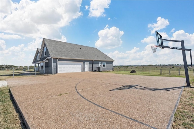 view of sport court with a rural view