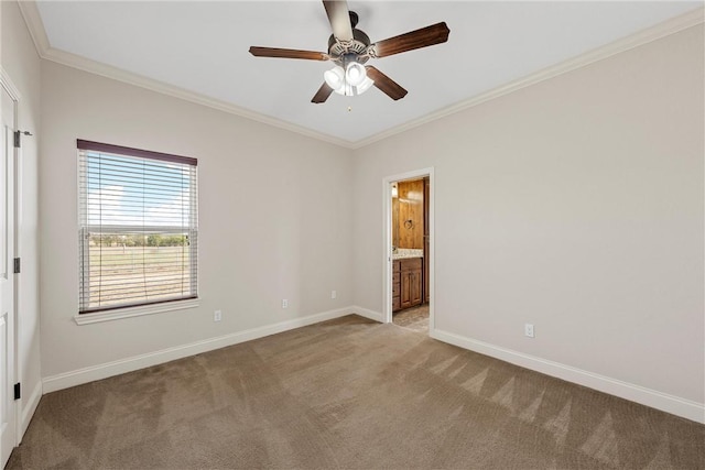 carpeted empty room featuring ceiling fan and crown molding